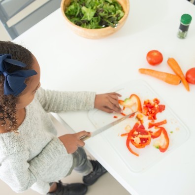 girl chopping peppers