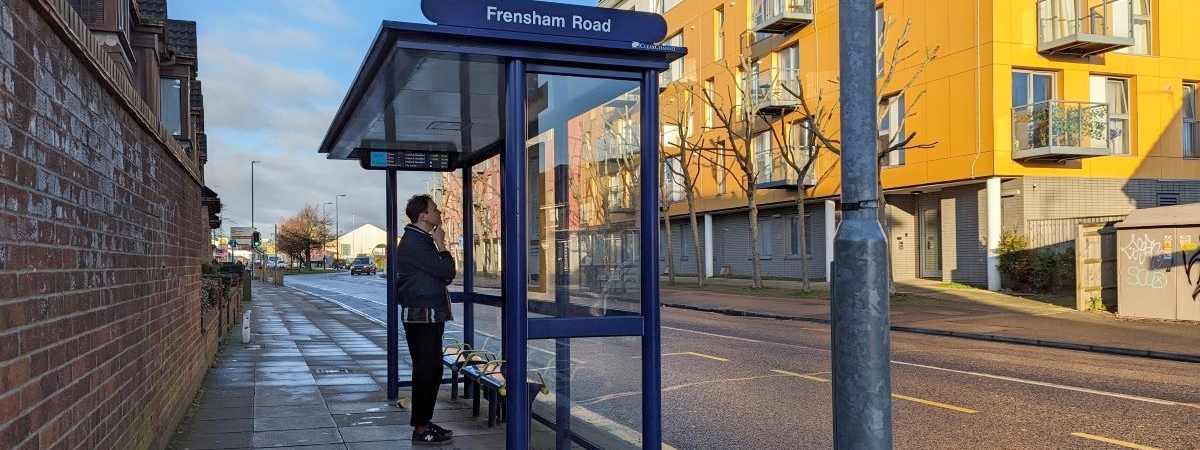 Man standing at Frensham Road bus stop