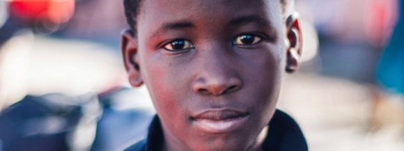 Young boy looking thoughtfully into the camera