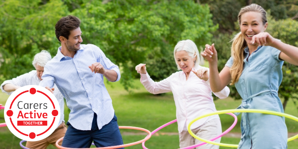 Logo with the words “Carers Active Together” beside an image of people hula hopping.