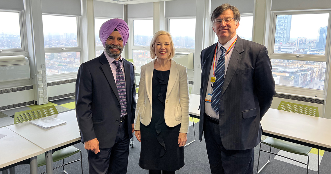 Leader standing with QMUL people