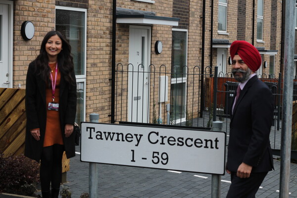 Cllr Solanki and Leader standing outside new homes