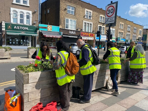 People in high-visibility jackets planting flowers