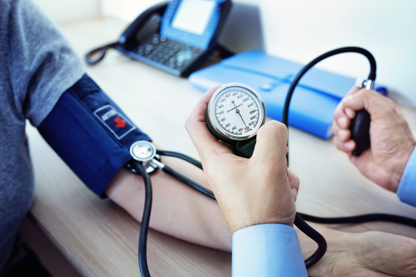 Doctor measuring blood pressure of patient