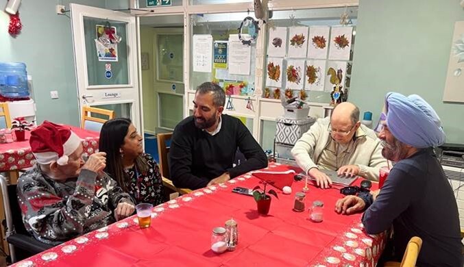 Cllr Jas Athwal speaking to care home resident