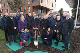 Staff and residents planting a tree