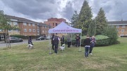 Resident engagement officers at an estate with a tent with the words 'Come and speak to us'