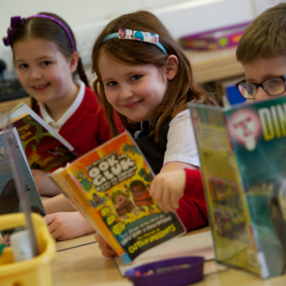 Primary school pupils reading books