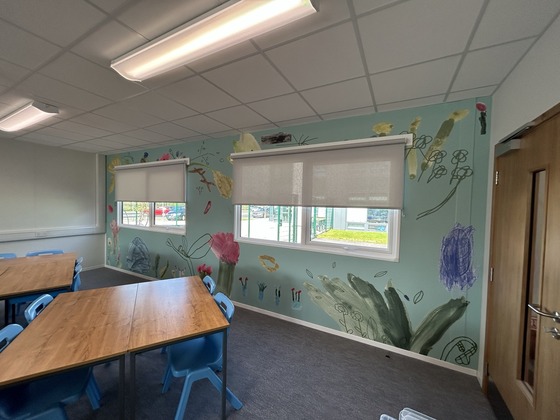 Classroom with artwork of flowers on the wall with windows