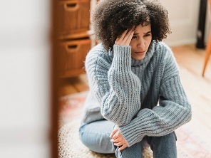 woman crouched and contemplating