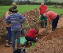 People digging in trench.