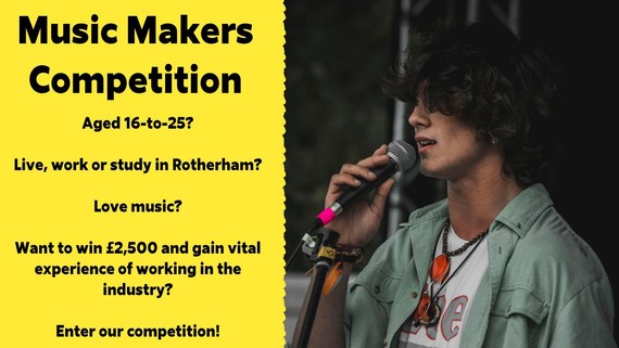 Young man sits playing a guitar