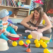 Child and adult making music with upturned bowls