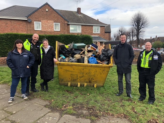 people in front of skip