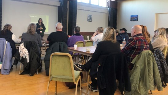 People sat in hall listening to a presentation