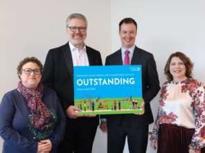 People stood with small display board