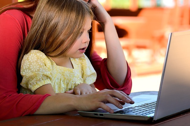 Child and parent using computer