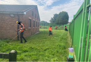 Wednesbury Clean-Up Day - group cuts the grass and tidies the outside of the club