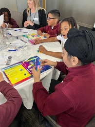 A child making a structure from lego at the conference.