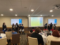 Primary school children delivering a presentation in front of their peers at the conference.