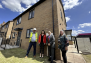 A group of people stand in front of a newly built Sandwell home