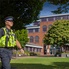 Police officer walking in front of Council House Oldbury