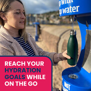 Person topping up a reusable water bottle on MInehead Sea Front