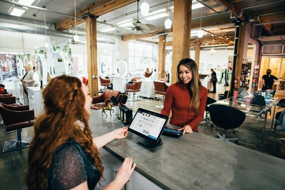 image of two women speaking with laptops