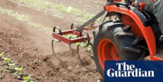 A tractor driving on a ploughed field