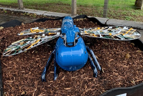 A large dragonfly sculpture that has been made out of rubbish, including spanner for the wings