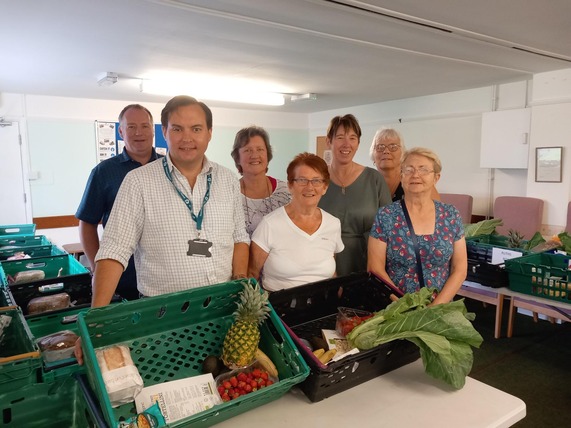 Cllr Theo Butt Philips with the Highbridge & Burnham on Sea Local Pantry team preparing items for the hampers