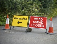 Road ahead closed and diversion signs