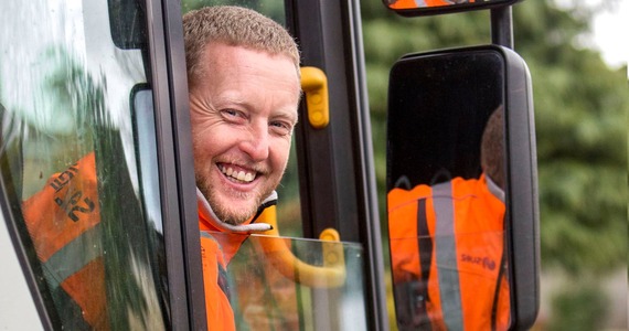 Recycling lorry driver smiling out the window