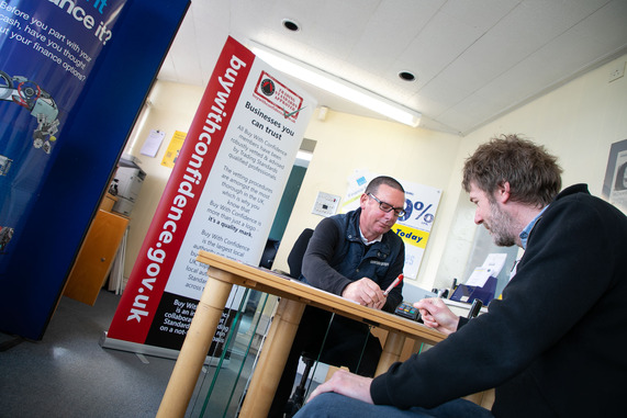 an image of two men discussing the Buy with Confidence scheme