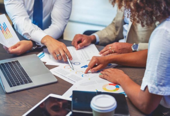 image of people collaborating around table