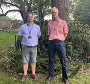 Tree Officer, Craig and Tree Strategist, James standing in front of a tree