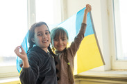 Two little girls with a Ukrainian flag