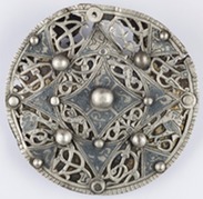 Round silver broach, finely decorated and features silver pearl-like balls