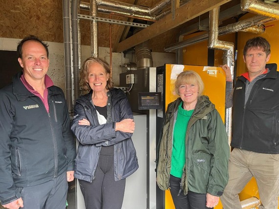 The team at Pinkery next to the new biomass boiler
