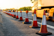 A row of traffic cones on a road.