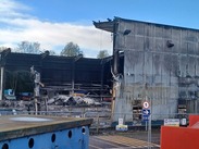 The fire damaged Materials Recovery Facility undergoing demolition.