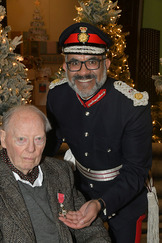 John Bishton receiving his MBE from the Lord-Lieutenant of Somerset, Mohammed Saddiq.