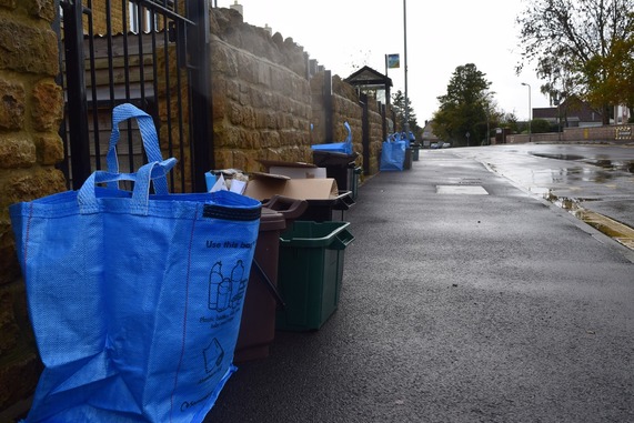 Recycling boxes lined up down the street