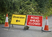 Road ahead closed and diversion signs.