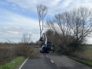 A digger removing a tree branch on the A361.