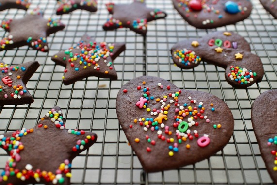 Homemade chocolate heart shaped biscuits, topped with Hundreds-and-Thousands sprinkles.