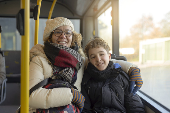 A woman and her child travelling on a public bus like the No 1 service.