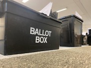 Photo of a black ballot box.