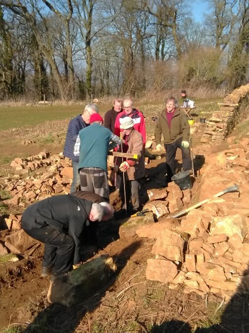 people working on a dry stone wall at Ham Hill