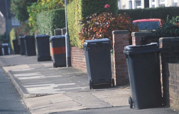 Wheelie bins for rubbish lined along a street